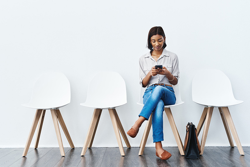 Woman on Phone With Four Chairs