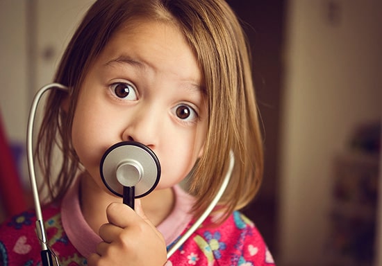 Cute little girl using a stethoscope