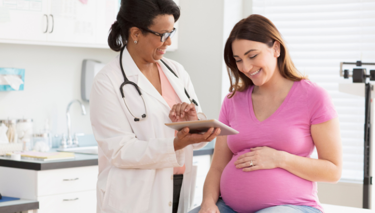 Pregnant woman getting a doctor's check up - explore the services covered by a Blue Cross and Blue Shield of Illinois plan